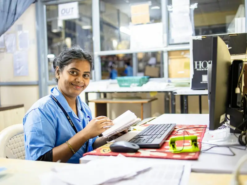 A member of an office team in India working at her desk